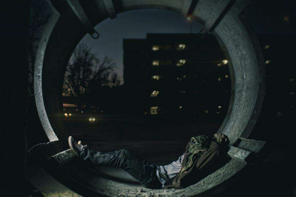 Person laying in a hallway with a building in the background